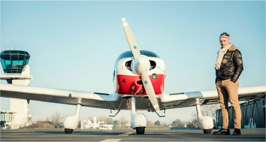 man in front of small plane